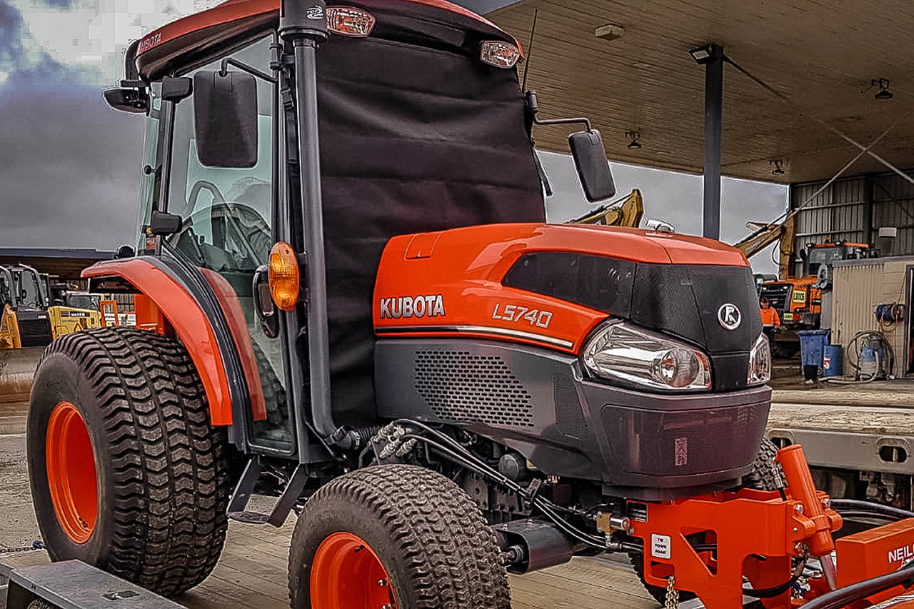 Orange Kubota L5740 Tractor with windscreen protector