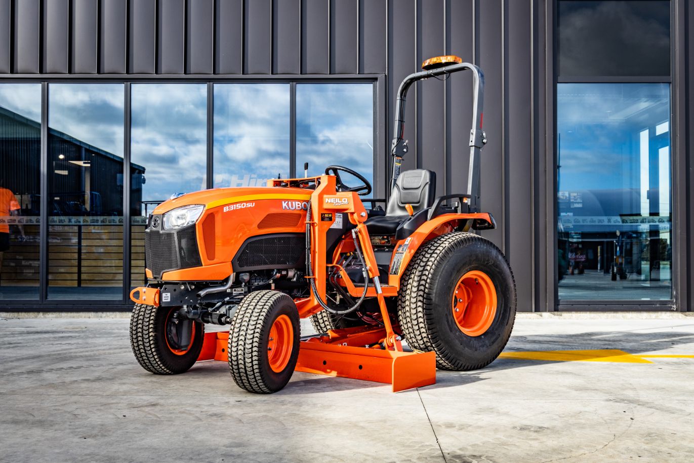 Orange mini tractor grader