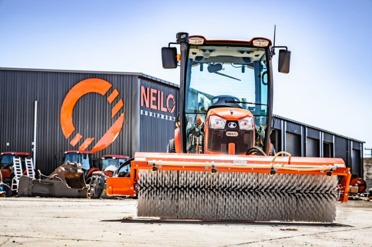 Orange Kubota B3150 Tractor with large Neilo Broom at Neilo production facilities
